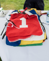 A stack of numbered jerseys for the participants, with "1" on top