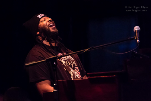Delvon Lamarr tosses his head back joyfully while he plays organ
