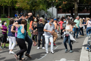 A crowd dances in front of the Mural Amphitheatre stage at Seattle Center
