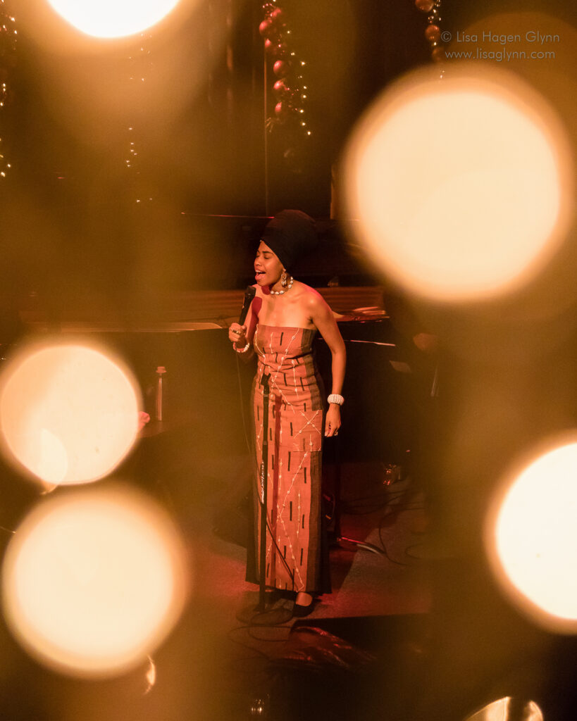 Jazzmeia Horn through bokeh of holiday lights