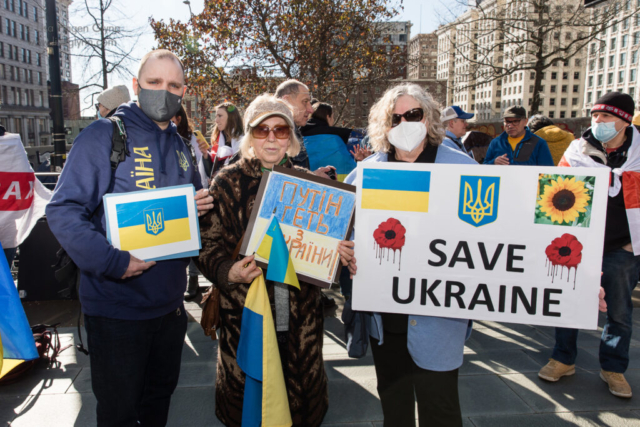 A sign reads, "Save Ukraine."