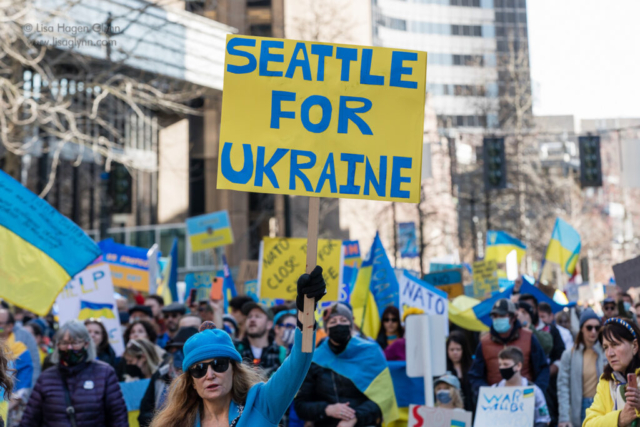A marcher carries a sign that reads, "Seattle for Ukraine."