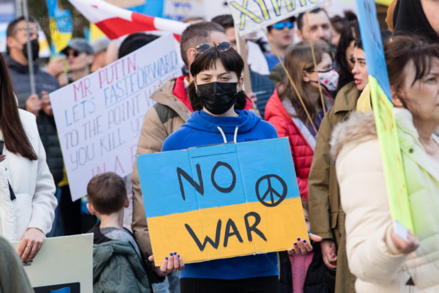 A sign reads, "No war"