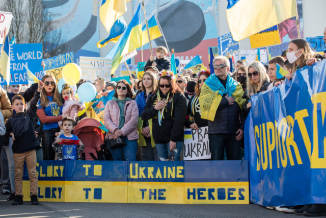 Participants stand for the Ukrainian national anthem