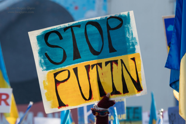 Sign reads, "Stop Putin" in blue and yellow