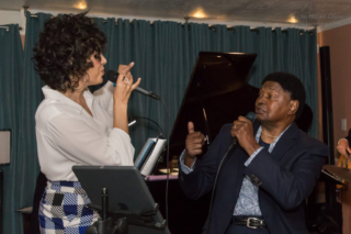 Darelle Holden and Dave Holden, Sr. sing together.