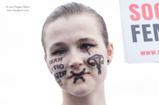 A protester wears face paint