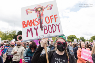 A sign reads, "Bans off my body"