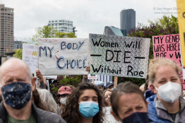 Protesters hold abortion-rights signs