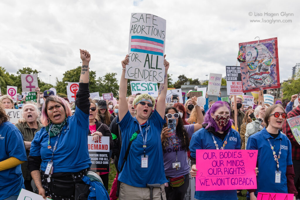 Protesters shout and hold signs