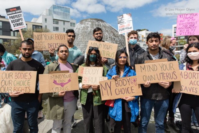 A group holds cardboard abortion-rights signs