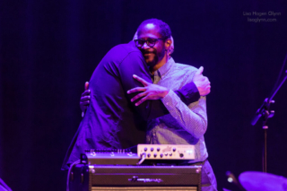 Scott Colley and Brian Blade hug after the show.