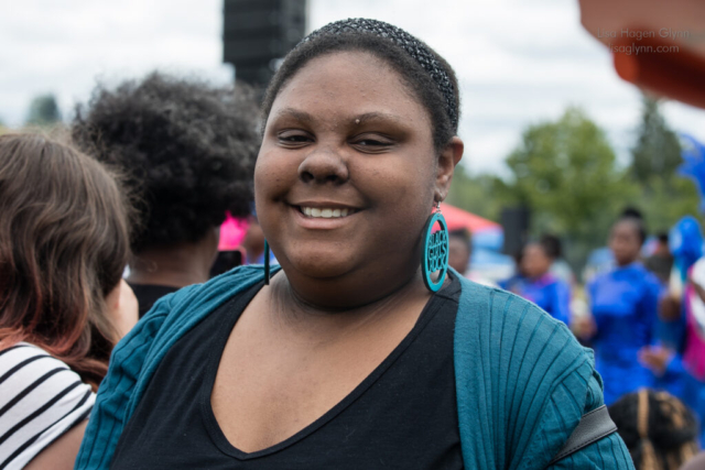 An attendee wears earrings that read, "Black girls rock"