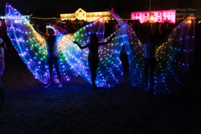 Lighted costumes, with Fort Worden behind