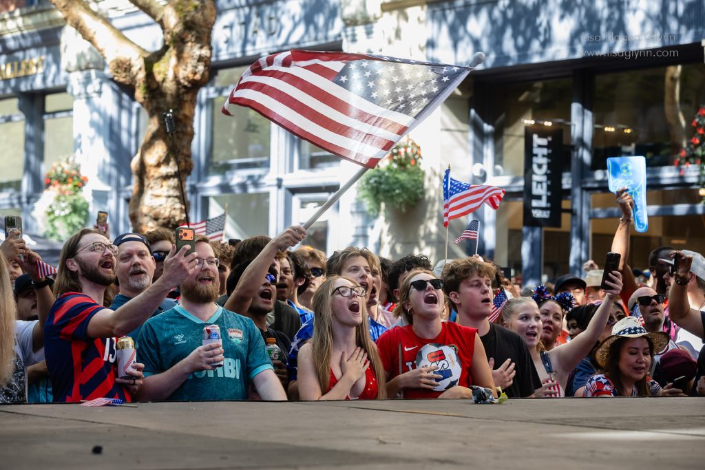 Fans sing the U.S. national anthem at a watch party in Seattle's Occidental Park. (Photo: Lisa Hagen Glynn)